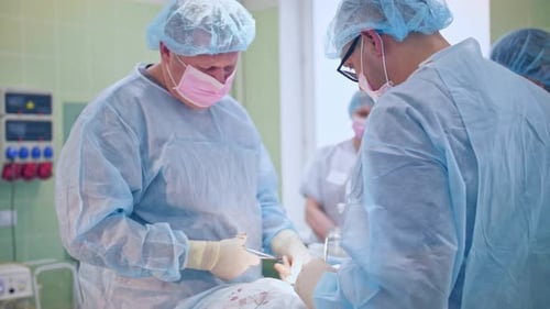 Surgeons Performing Operation in Hospital Operating Room