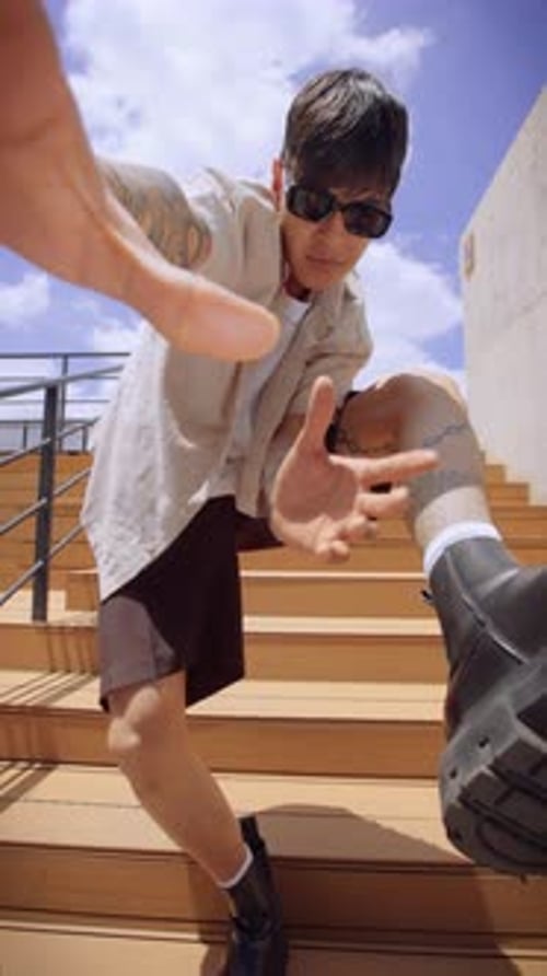 Man Poses on Stairs in Urban Fashion Shoot