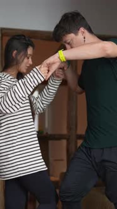 Couple Doing Hand and Arm Exercises Together