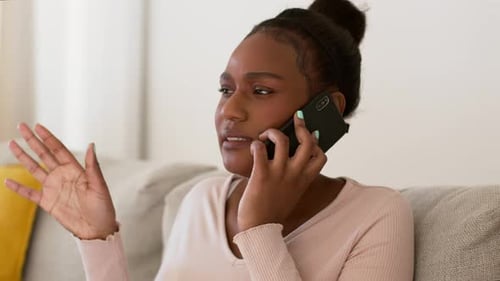 Woman Sitting on Couch Talking on Cell Phone