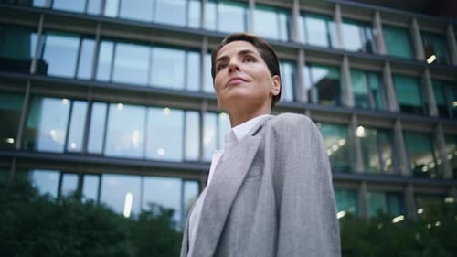 Confident Businesswoman Standing by Modern Office Building