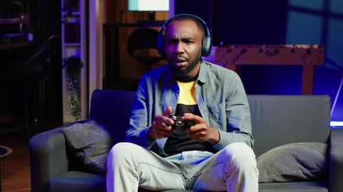 Young Adult Immersed in Video Gaming at Home