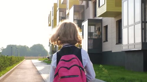 Little Girl with Backpack Going to School