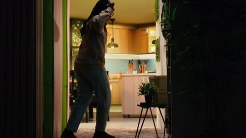 Woman Dances to Music in Apartment at Night