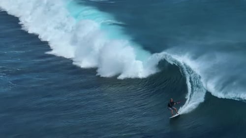 An Athlete on a Wave Board Rides the Big Ocean Waves of a Living Reef in the Indian Ocean