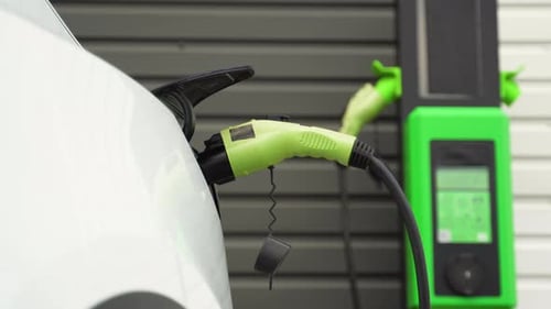 Luxury White Electric Car is Charged at the Station Eco Friendly Fuel