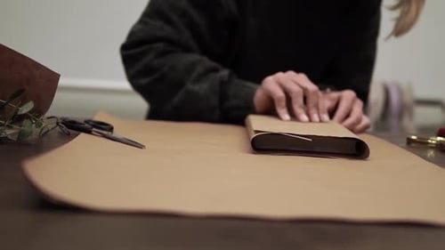 Wrapping Book with Brown Paper for a Gift