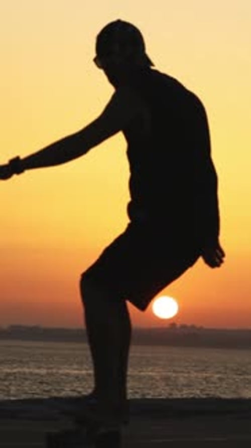 Silhouette of Skateboarder at Sunset on the Beach