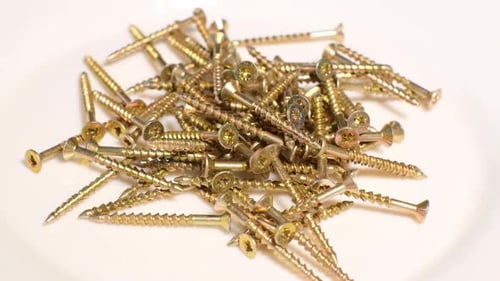 Yellow Metal Screws Rotate in a Circle Fasteners When Working with Wood and Plasterboard