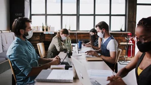 Young Business People with Face Masks Working Indoors in Office, Coronavirus Concept