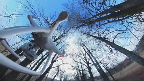 Close-up Side View of Dji Phantom 4 Quadcopter Drone Flying Backwards Over A Country Gravel Road Amo