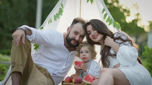 Happy Family Together Enjoying Picnic in Countryside