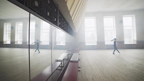 Person Practicing Dance Moves in Bright Studio