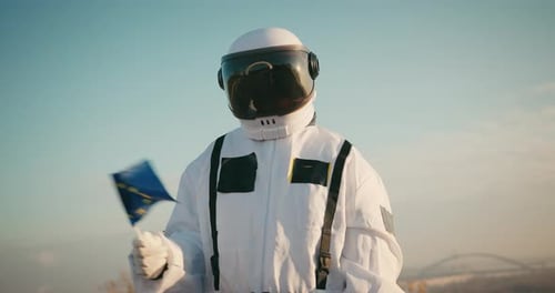 Astronaut Holding a Flag Overlooking a City