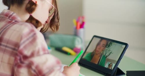 Girl Attends Class Using Tablet At Home