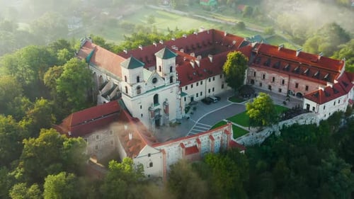 Aerial drone view of Benedictine Abbey over Vistula river in Tyniec in the morning fog, Krakow, Pola