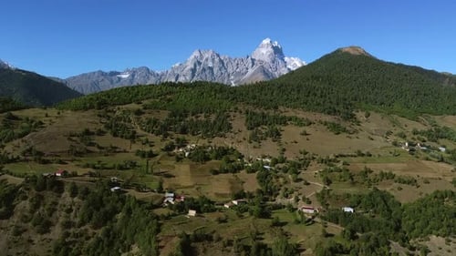 Scenic Rural Landscape with Majestic Mountains and Village