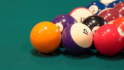Person Breaks Pool Balls on 8 Ball Triangle Rack Closeup on the Spot with Solid and Stripped Billiar