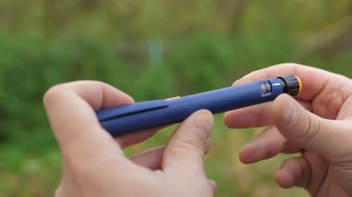 Injection Pen Being Prepared Outdoors in Daylight