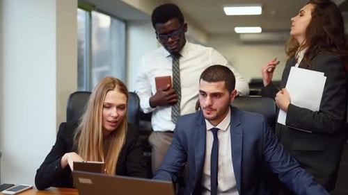 Diverse Office Corporate Workers Discuss Project on Laptop Display in Office Multiethnic People