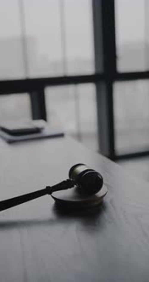 Judge’s Gavel Striking Wooden Block In Courtroom