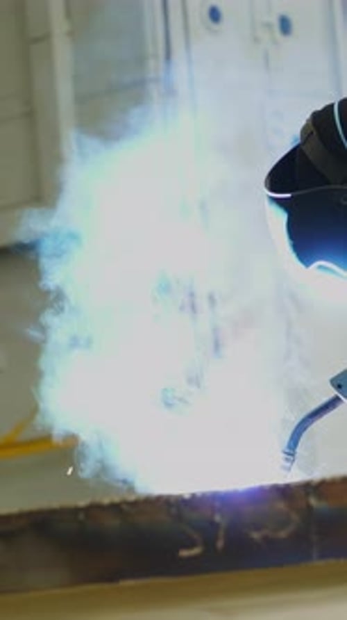 Industrial Worker Welding Metal in Factory Stock Clip