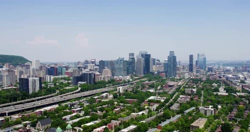 Aerial view backwards over the Petite-Bourgogne district, in sunny Montreal, Canada