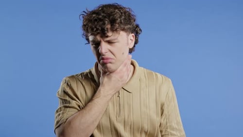Ill Handsome Man Has Sore Guy With Swollen Throat On Blue Studio Angina Pain