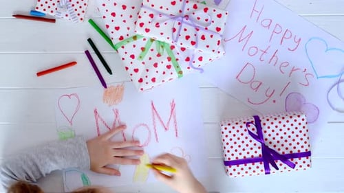 Child Draws Mother's Day Card with Presents