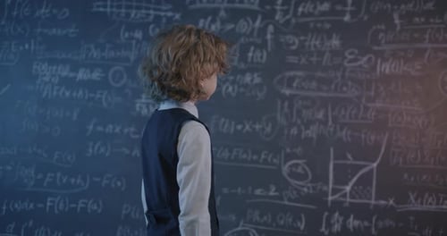 Child Facing Math Equations on Chalkboard