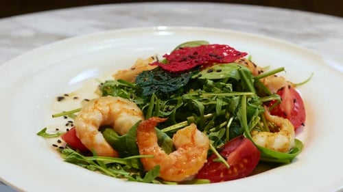 Close Up of Salad on a White Plate Arugula Tomato Shrimps Healthy and Wholesome Food Serving Food in