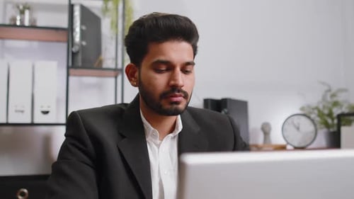 Closeup Businessman Freelancer at Office Workplace Working on Laptop Computer Sends Online Messages