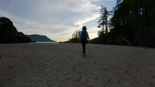 Woman Walking on Sandy Beach on Pacific Ocean Coast View