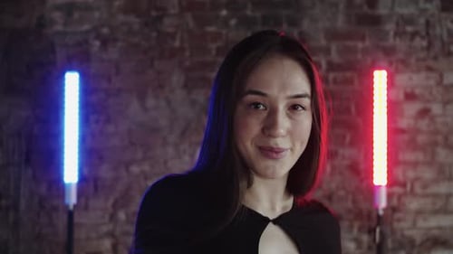 Stylish Woman Posing in Front of Brick Wall
