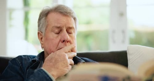 Reading book, thinking and senior man in home living room on sofa to relax with novel