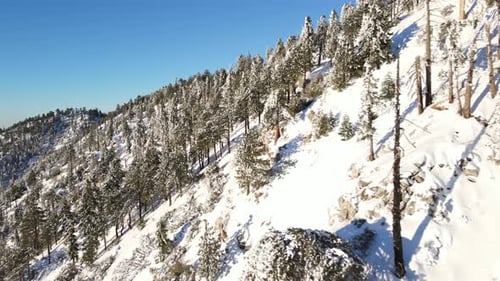Aerial of a road through the mountains after a snow