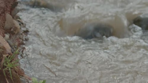 River Flowing Rapidly Over Rocks
