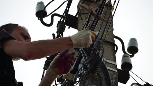 Lineman Working on Utility Pole Electrical Lines