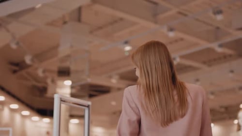 Woman Walking into Clothes Shop with Excitement