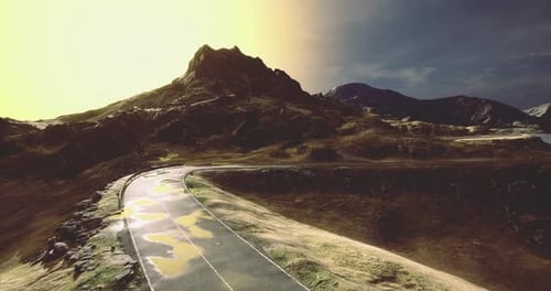 Majestic Mountain Road Under a Brilliant Sunset Illuminating the Landscape