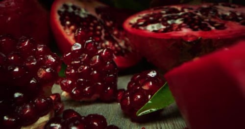 super macro slide shot of pomegranate on a wooden bench, in slow motion. Concept: food, fruit, nat