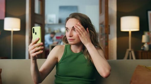 Shocked Woman Watching Cellphone at Home Closeup. Surprised Lady Face Reading Mobile