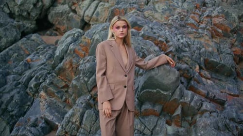 Elegant Woman Posing Outdoors on Rocky Beach Attractive Young Blonde Looking