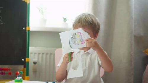 Diligent Boy Cuts Out Circle with Drawing of Copybook Page