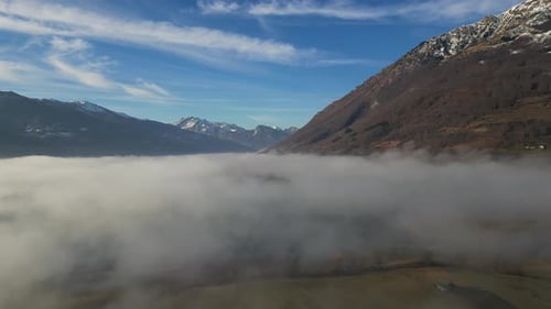A Drone Flies Over Fields and Lakes Covered with Thick Morning Fog