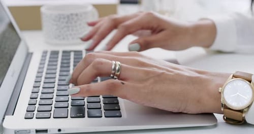 4k video footage of an unrecognizable businessperson using a laptop at work