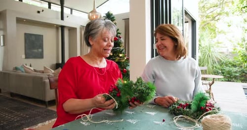 Women Making Christmas Wreaths at Home