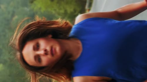 Portrait of woman running on empty mountain road in morning. Vertical video