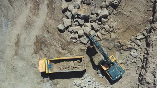 Earthmoving equipment. Aerial view of construction site with earthmover and truck machines