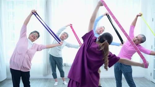 Seniors Doing Arm Raises With Exercise Bands